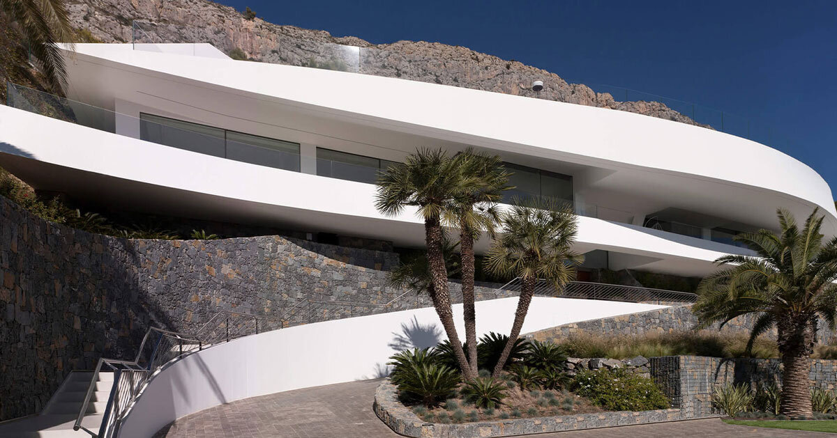 curved house's sinuous facade traces mountainous terrain in spain