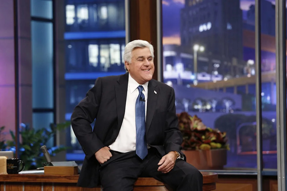 jay leno sitting on his desk on the tonight show