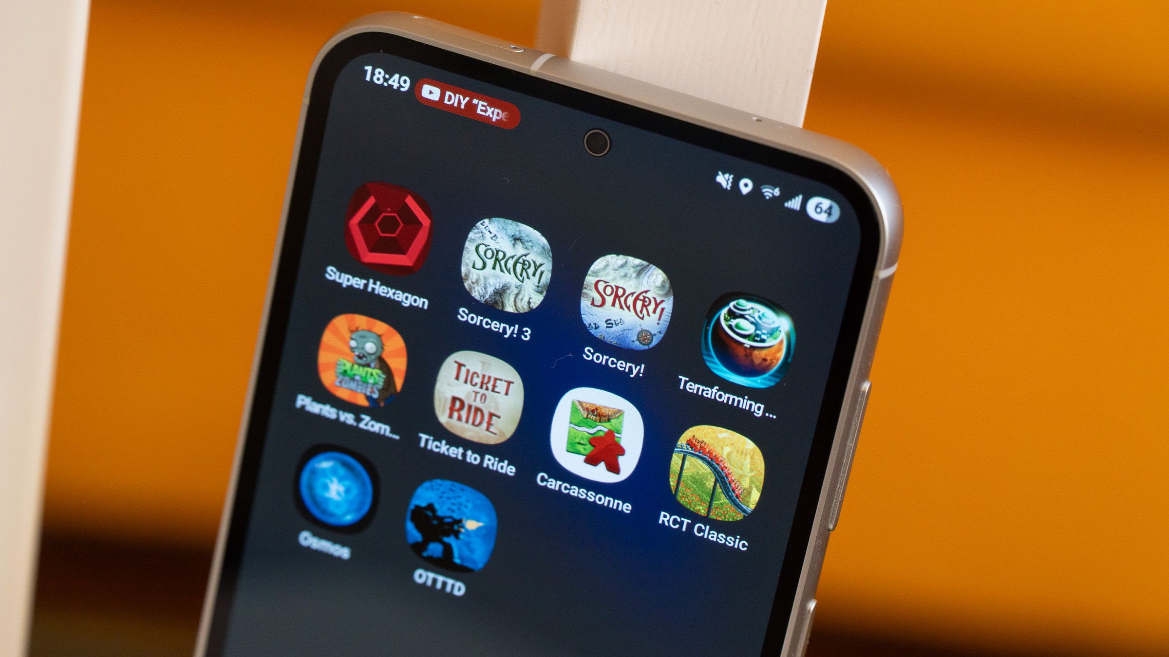 a closeup of a phone with game icons displayed