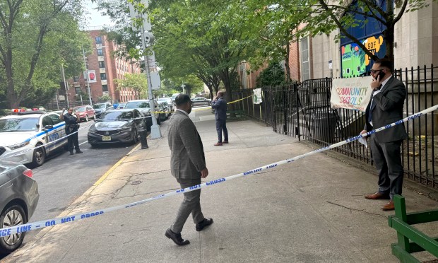 Police investigate at the scene of a homicide outside PS 174 on Dumont Ave. in Brooklyn on Saturday morning.