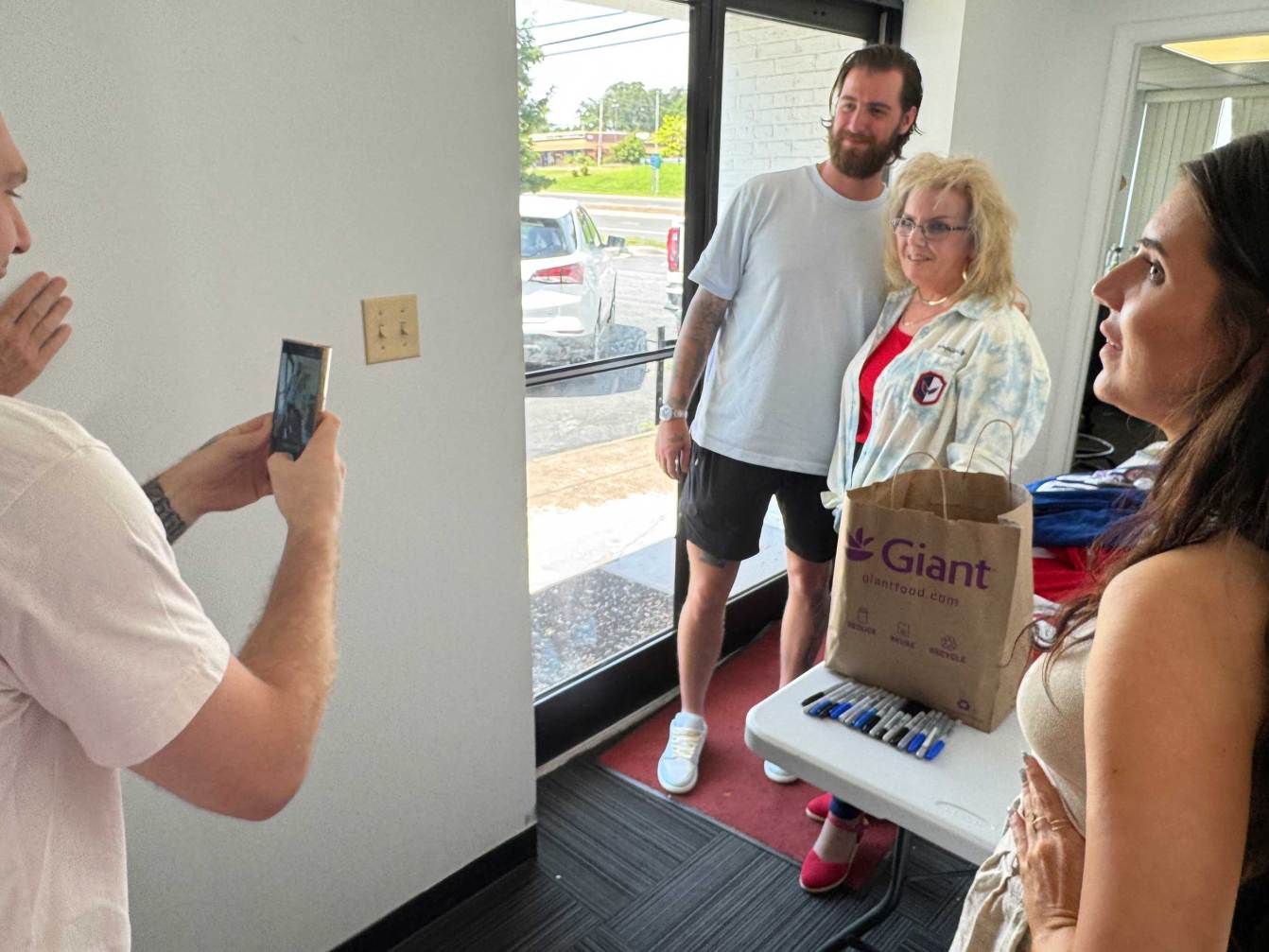 Evgeny Kuznetsov photographs Logan Thompson with a Capitals fan