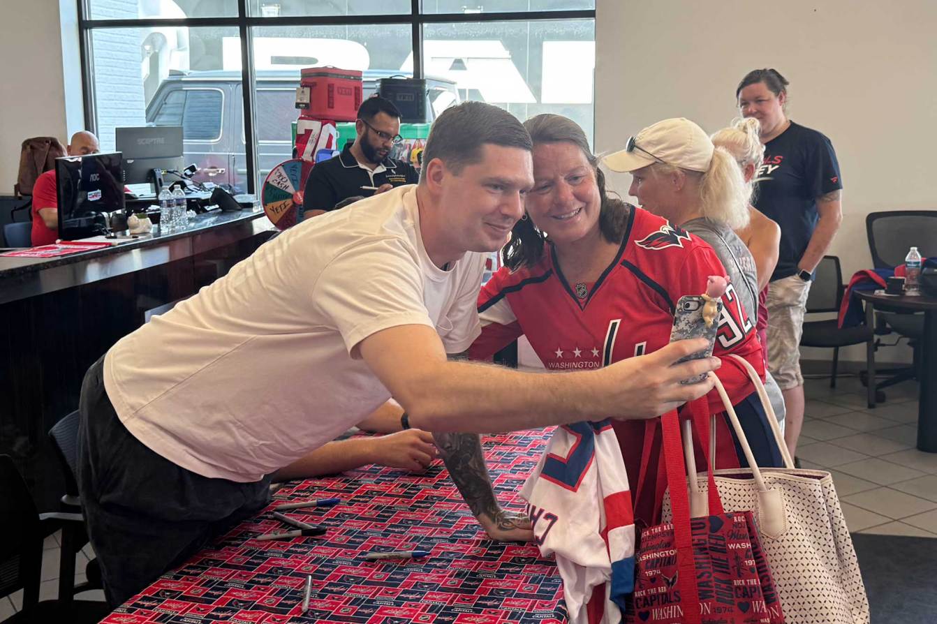 Evgeny Kuznetsov takes a selfie with a Capitals fan