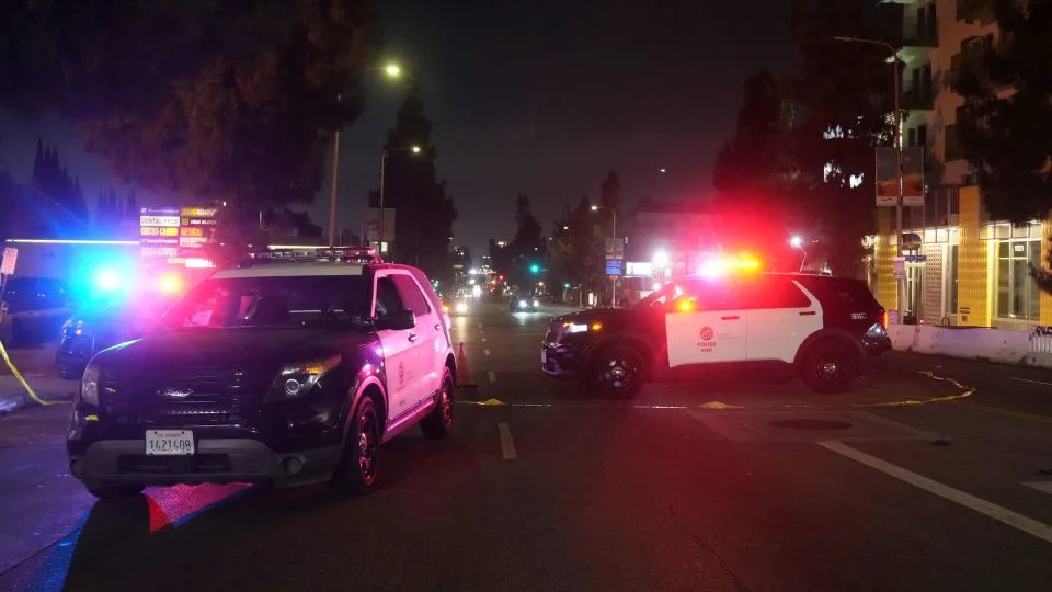 Police patrol vehicles close Vermont Ave. after a vehicle rammed into a crowd gathered outside "The Vermont" nightclub in Los Angeles, early Saturday. - Damian Dovarganes/AP