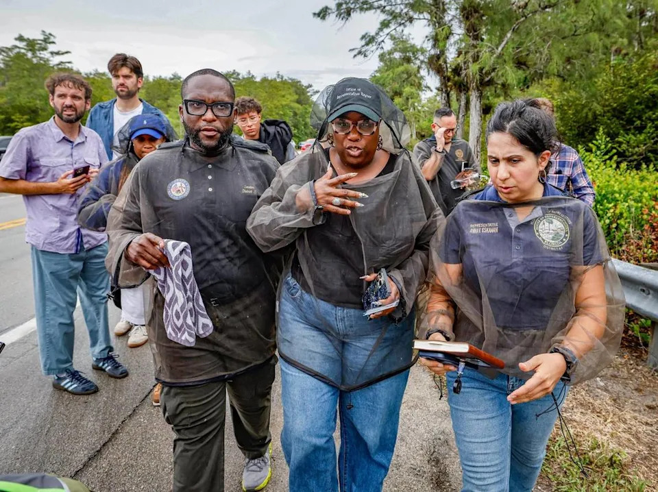 With mosquito nets, Florida Sen. Shevrin Jones and state Reps. Michele K. Rayner and Anna V. Eskamani are seen here with colleagues after being denied entry into Alligator Alcatraz.