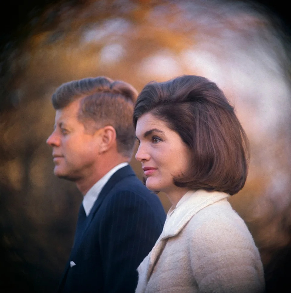 Jackie Kennedy and John F. Kennedt posing to the side in formal wear.