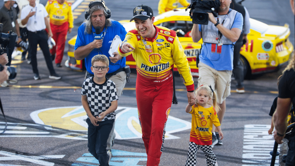 NASCAR Cup Series champion Joey Logano, left, is greeted by Mario Andretti, right, during the NASCAR Awards Show at Music City Center in Nashville, Tenn., Thursday, Dec. 1, 2022.