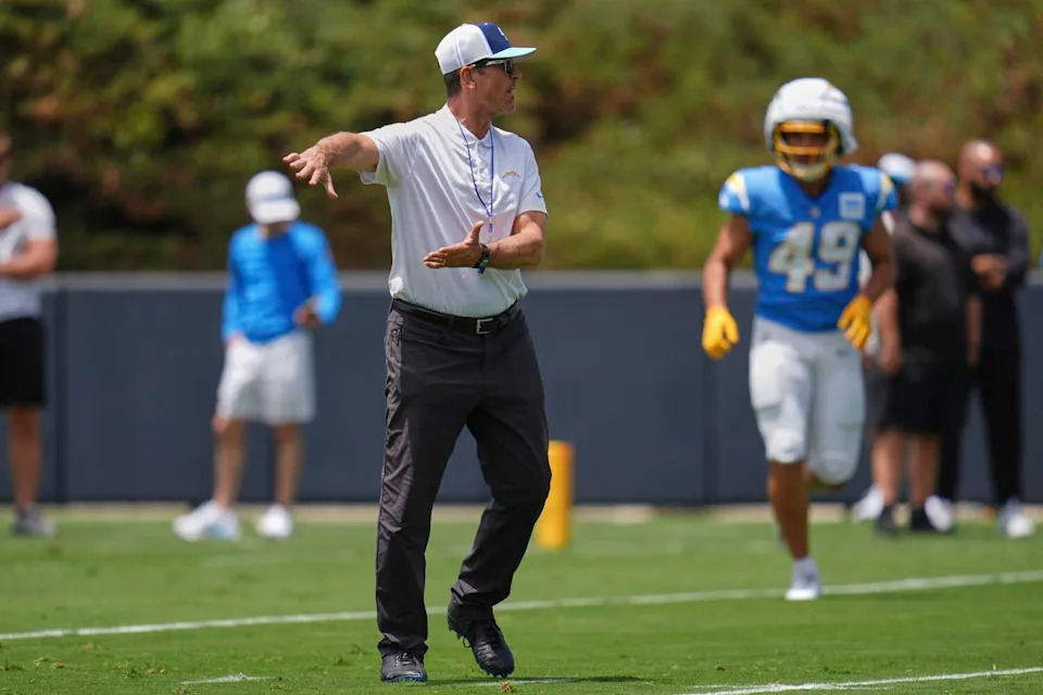 Chargers coach Jim Harbaugh instructs players during training camp in San Diego on Tuesday.