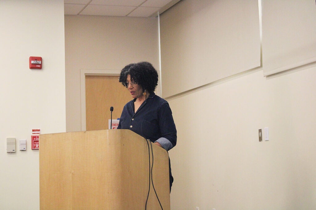 Lisa Sharon Harper, a juror in the tribunal and a South Philadelphia resident, stands at a podium