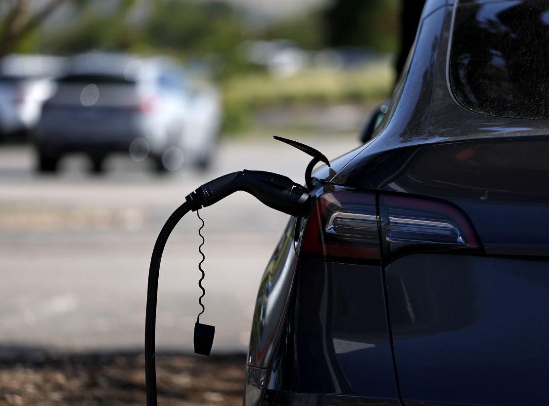 A Tesla car is parked at an electric vehicle charging station. Tesla sales have recently hit a rough patch.