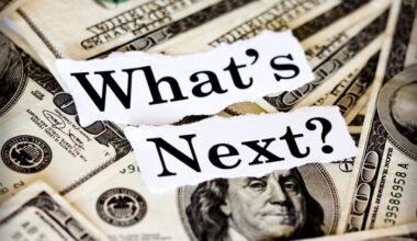 The words What's Next? cut out from a magazine and placed over a pile of $100 bills.