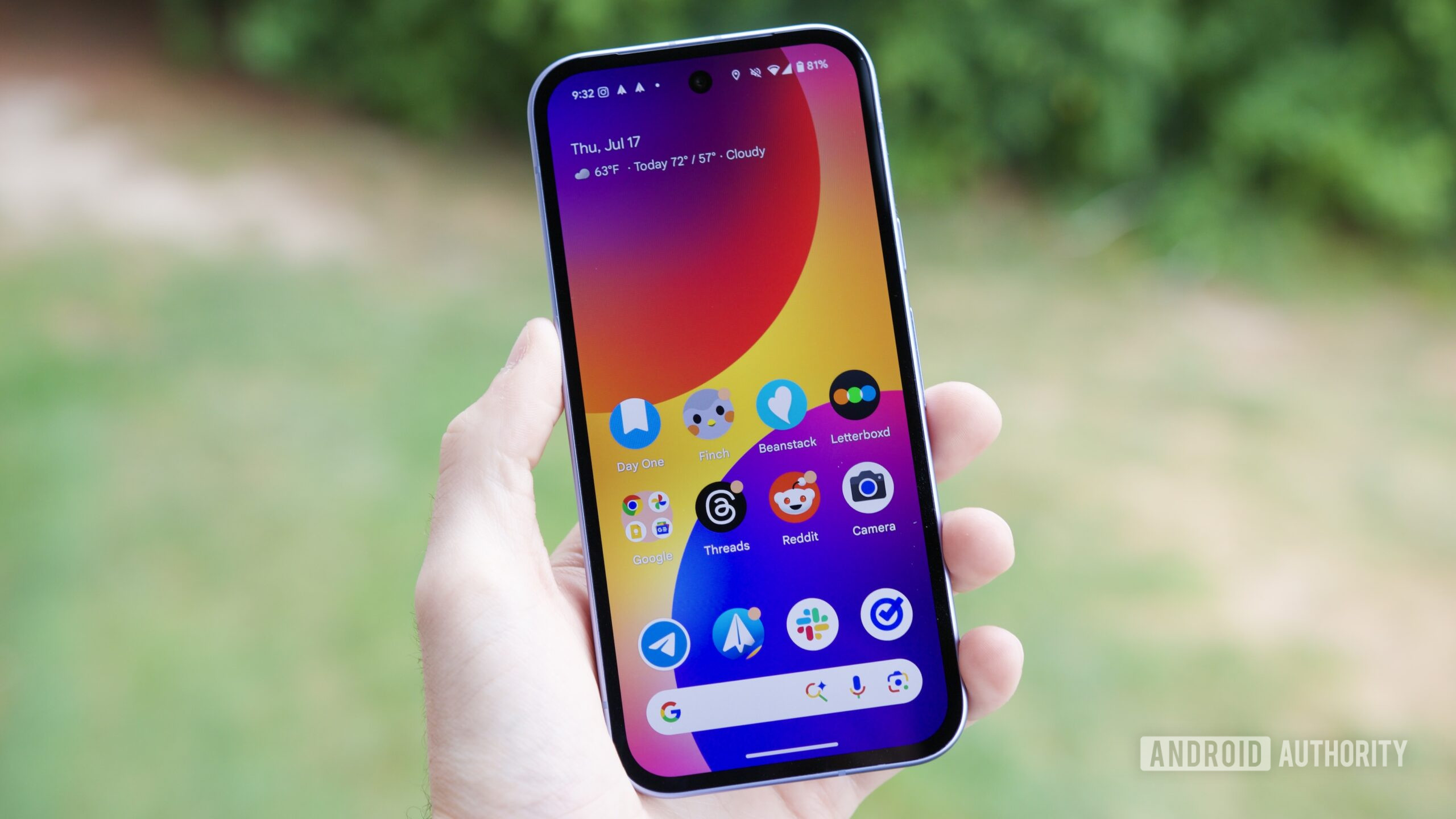 Someone holding a Google Pixel 9a with its screen on.
