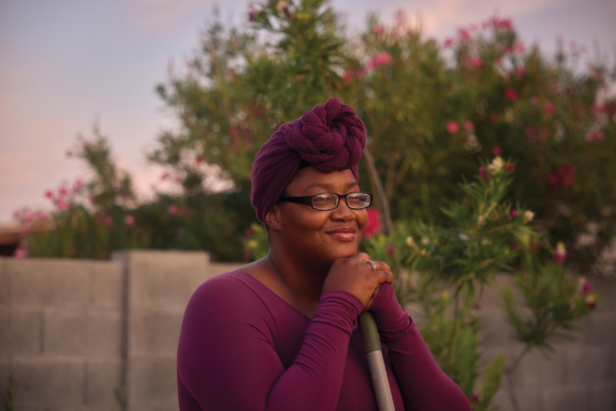 Tiffany Hawkins stands in the garden that her grandfather once kept before his death. In recent months, she has worked to revive it.