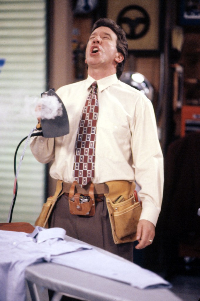 Tim Allen on Home Improvement holding a steaming iron.