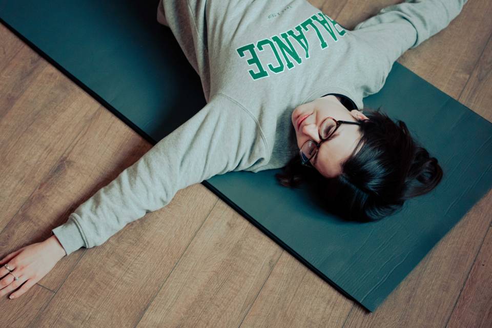 Woman lying on a yoga mat.