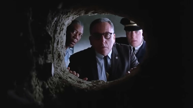 The Shawshank Redemption, the Warden, Red, and Captain Hadley looking through the hole in Andy's cell
