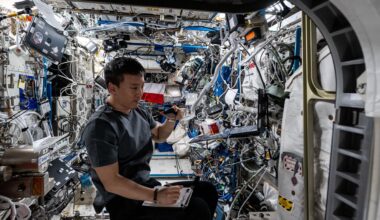 ASA astronaut and Expedition 73 Flight Engineer Jonny Kim conducts a ham radio session and takes notes inside the International Space Station's Columbus laboratory module.