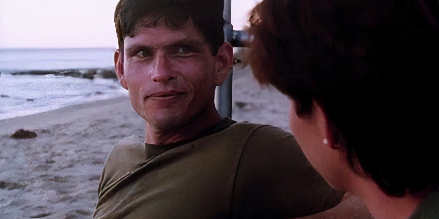 Jeff Kober as Winslow, sitting on the beach and grinning at someone in China Beach