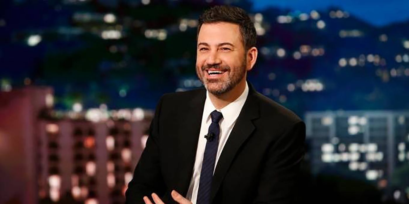 Jimmy Kimmel smiling behind his desk on Jimmy Kimmel Live!