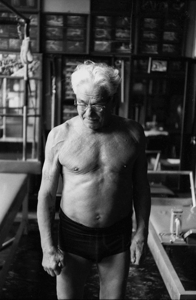 Black and white photo of Joe Pilates in his New York City studio.