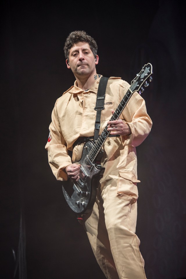 Joe Trohman of Fall Out Boy performing on stage.