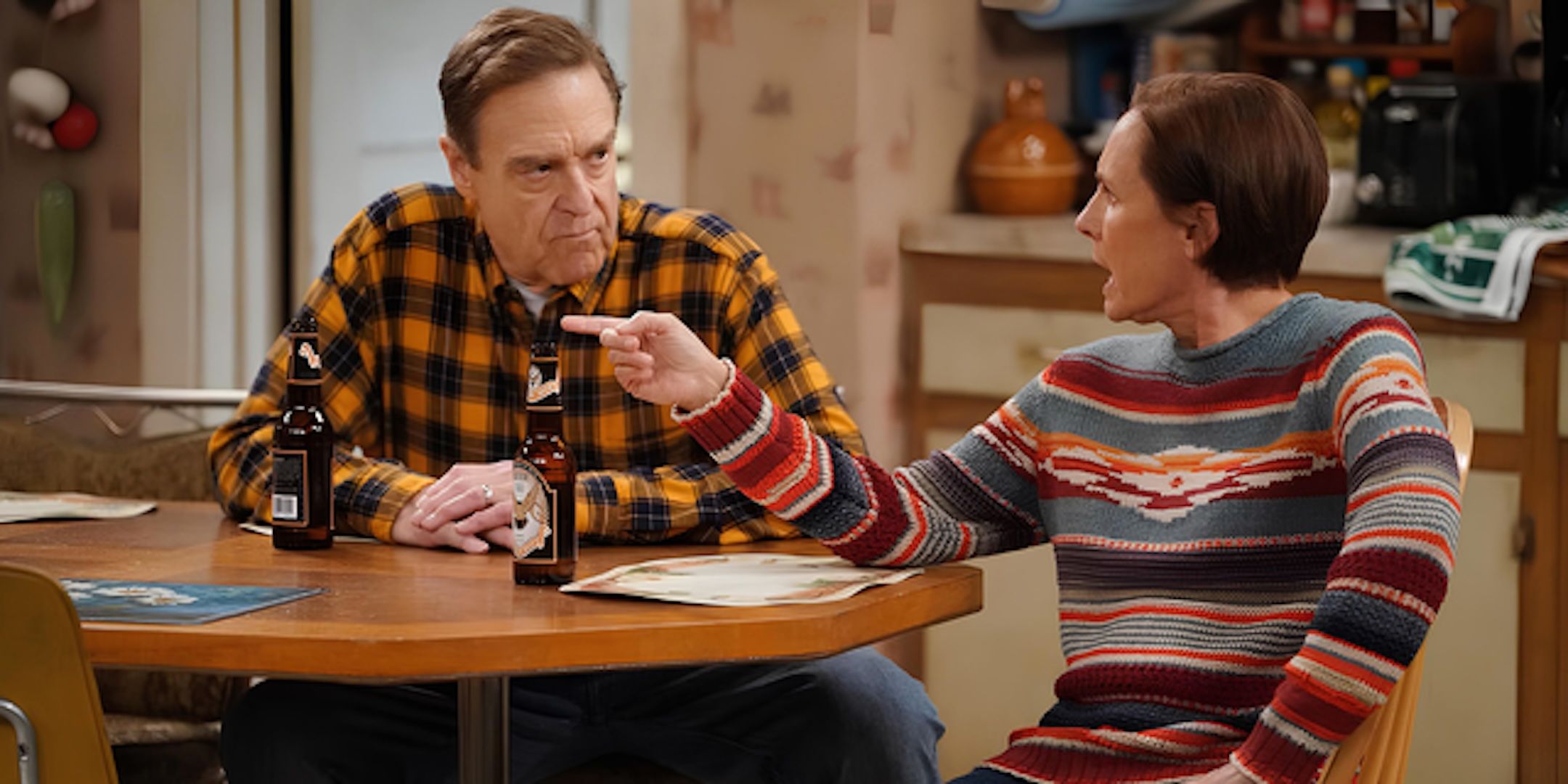 John Goodman's Dan and Laurie Metcalf's Jackie sit at the kitchen table arguing in The Conners