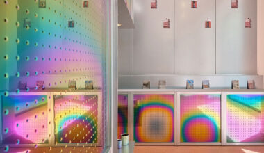 iridescent titanium panels cast reflections within info desk by KOGAA in brno