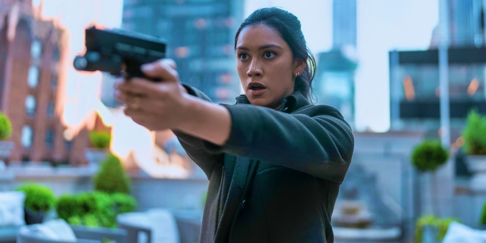 Luciane Buchanan as Rose pointing a gun in The Night Agent
