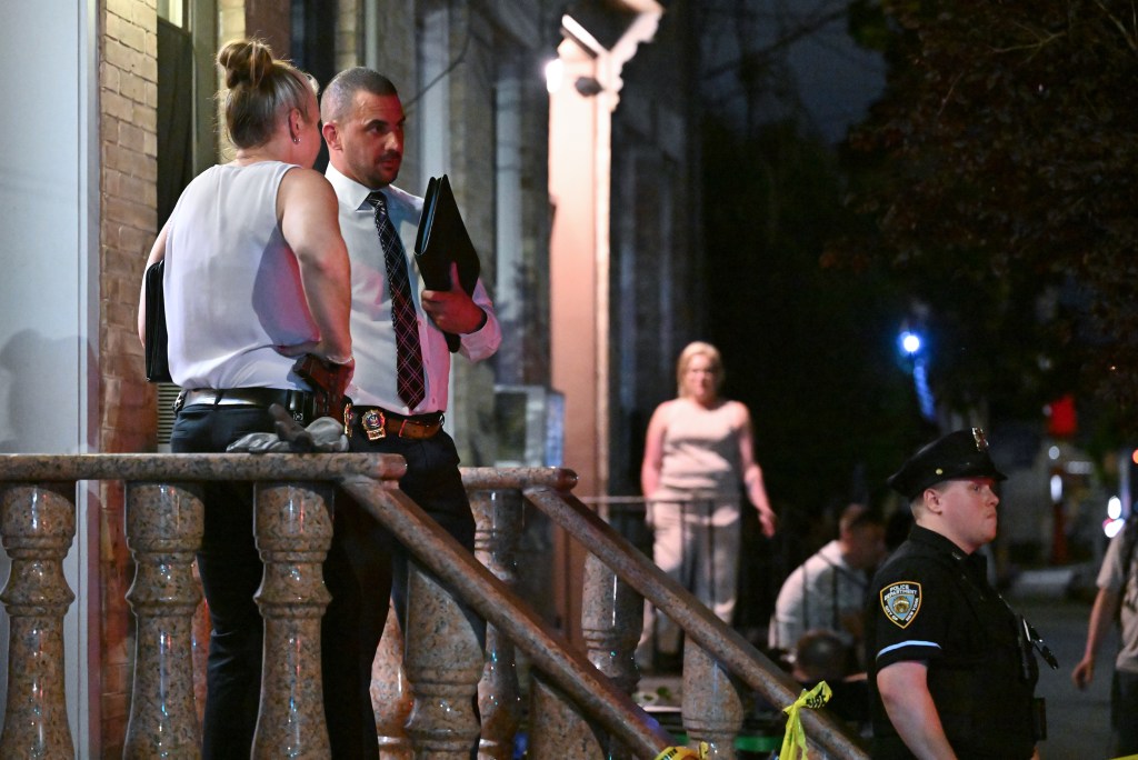 Police officers at the scene of a Queens murder-suicide.