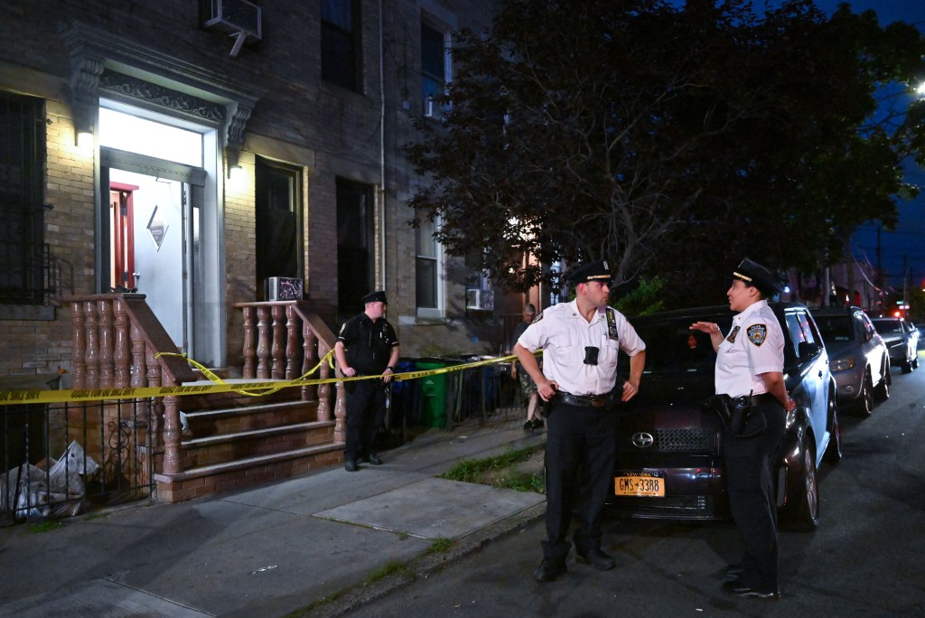 Police officers at the scene of a Queens murder-suicide.