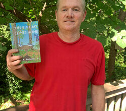 Gary Rockwood Jr. holding his book
