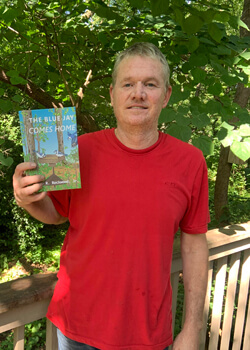 Gary Rockwood Jr. holding his book