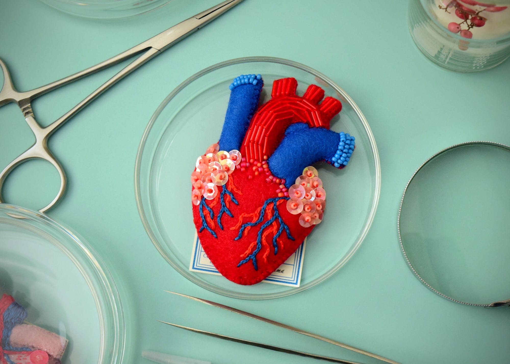 a felted brooch in the shape of an anatomical heart