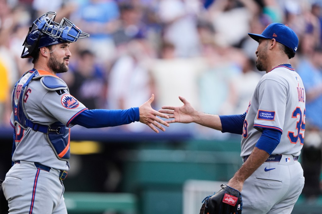 Edwin Diaz (R.) and Luis Torrens embrace after the Mets-Royals game on July 12, 2025. 