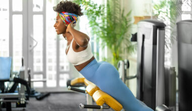 Woman using back extension machine in the gym