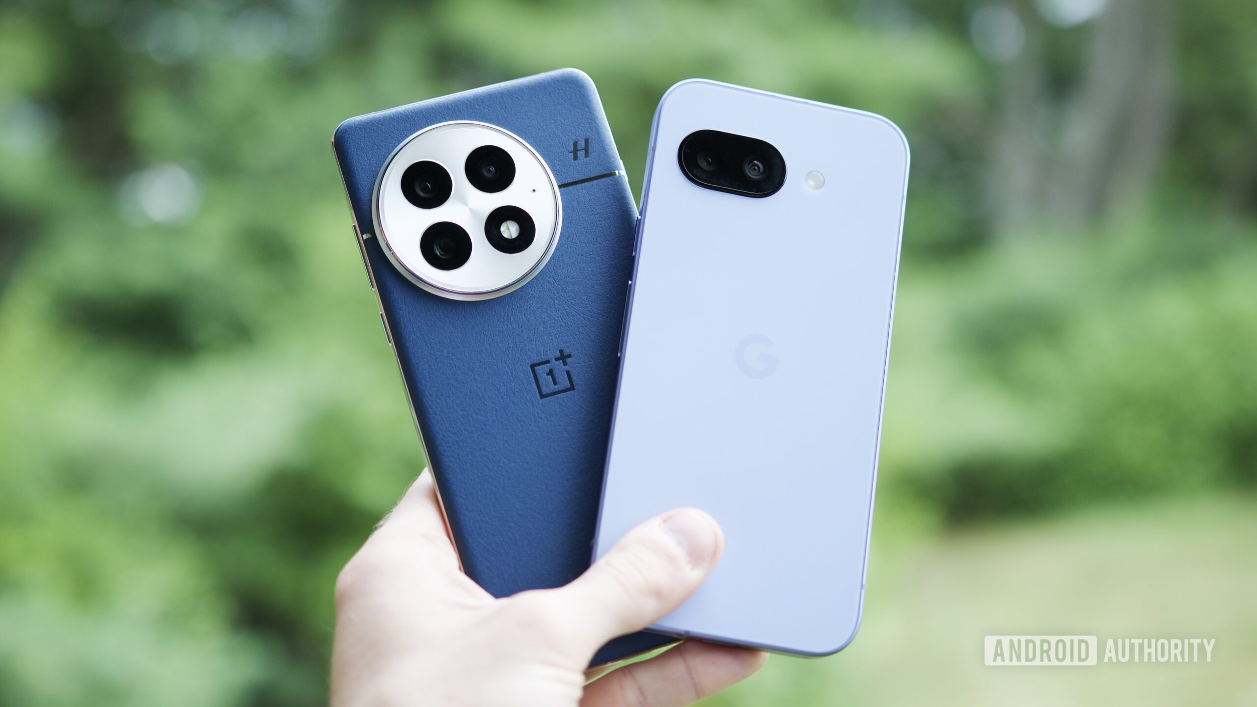 Someone holding a OnePlus 13 and Google Pixel 9a next to each other.