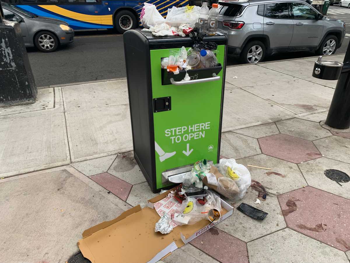 Overflowing litter baskets, spilling food and debris, burden NYC streets and sidewalks