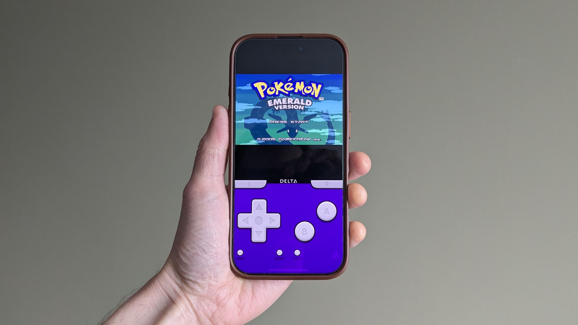 Pokémon Emerald being emulated on an iPhone 16 Pro.