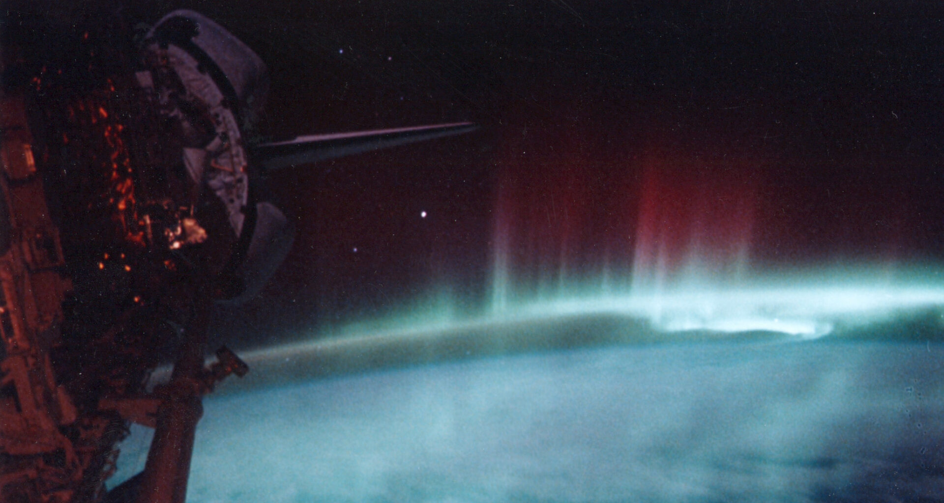 A red and green aurora as seen from outer space