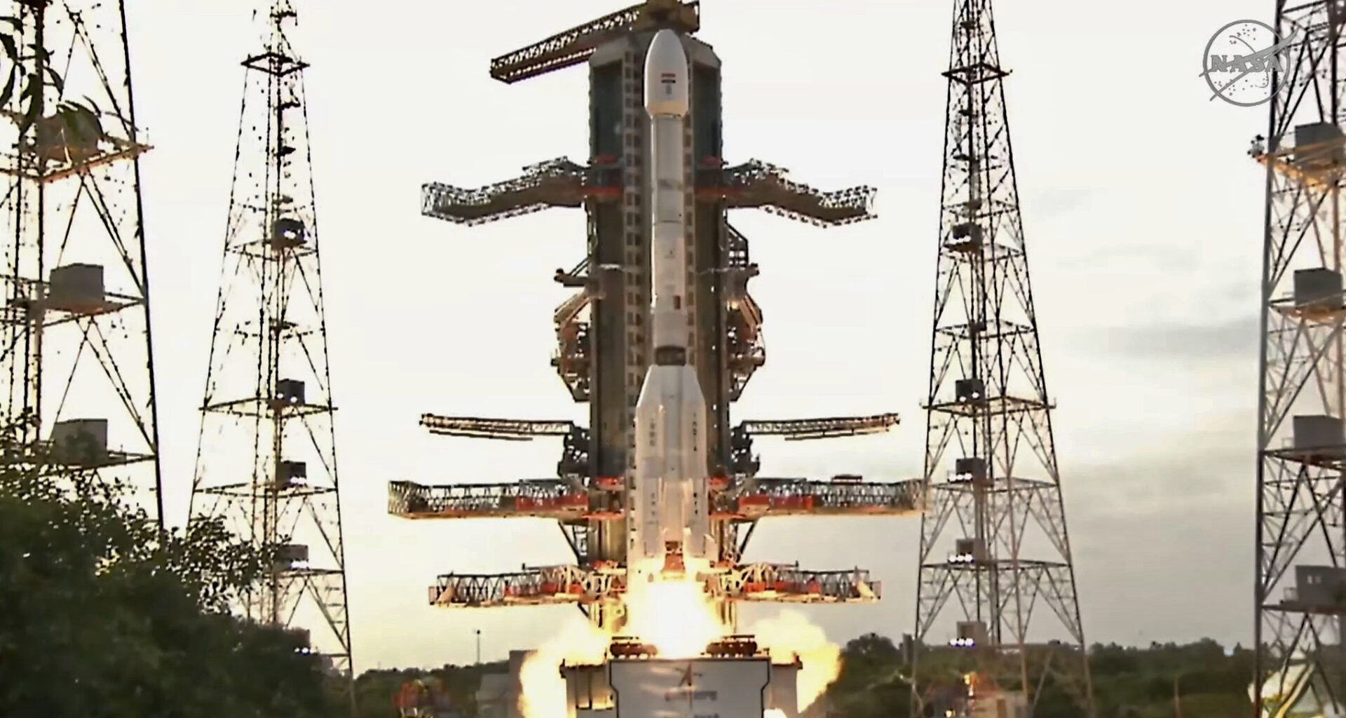 A white rocket with fat bottom lifts off
