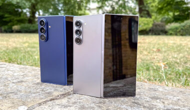 The Samsung Galaxy Z Fold 7 (blue, L) and Galaxy Z Fold 6 stood next to each other, partly folded