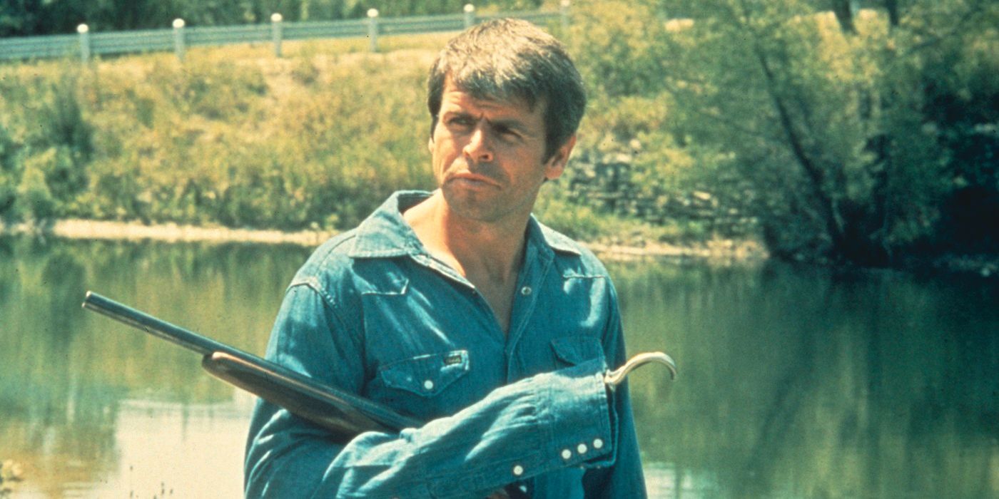 William Devane as Charles Rane standing by a river holding a rifle in 'Rolling Thunder'
