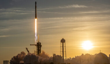 a rocket launches into a sunset sky