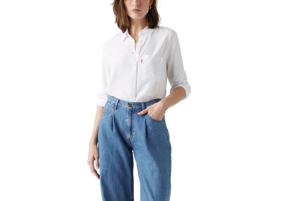 A woman in jeans and a white utility shirt