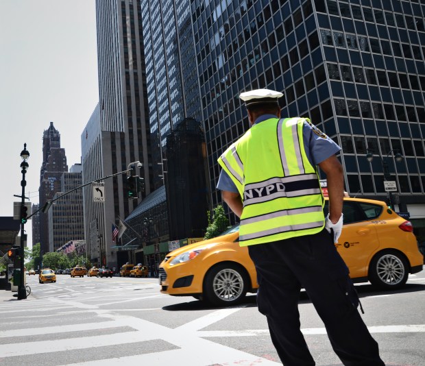 NYPD officer directing traffic in New York City. (Shutterstock)