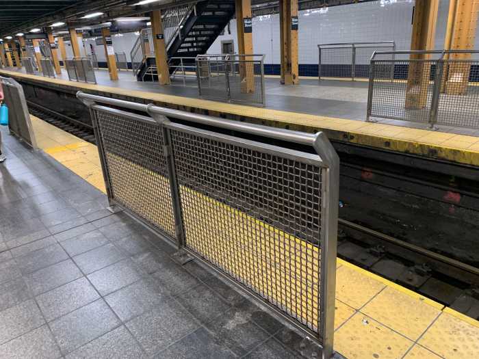 a subway station with protective barriers