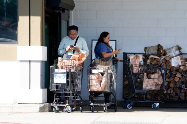 Late afternoon shoppers leave a local grocery store in Paradise Hills on Tuesday, July 8, 2025, in San Diego.  (Nelvin C. Cepeda / The San Diego Union-Tribune)