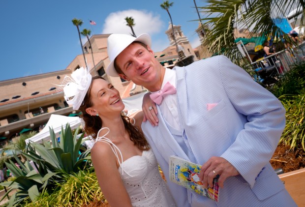 Shane Moore and his fiancee, Valeria Gioloso of Pacific Beach, took part in the annual tradition of wearing beautiful hats on opening day at the Del Mar Racetrack.  (Nelvin C. Cepeda / The San Diego Union-Tribune)