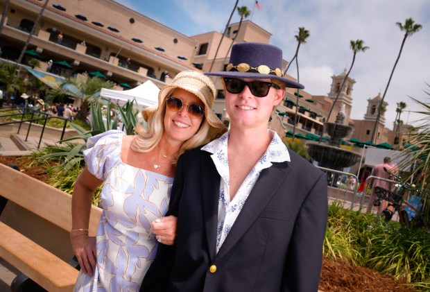 Heather Meyer and her son, Reynold Meyer of El Cajon were among those wearing beautiful hats on opening day at the Del Mar Racetrack. (Nelvin C. Cepeda / The San Diego Union-Tribune)
