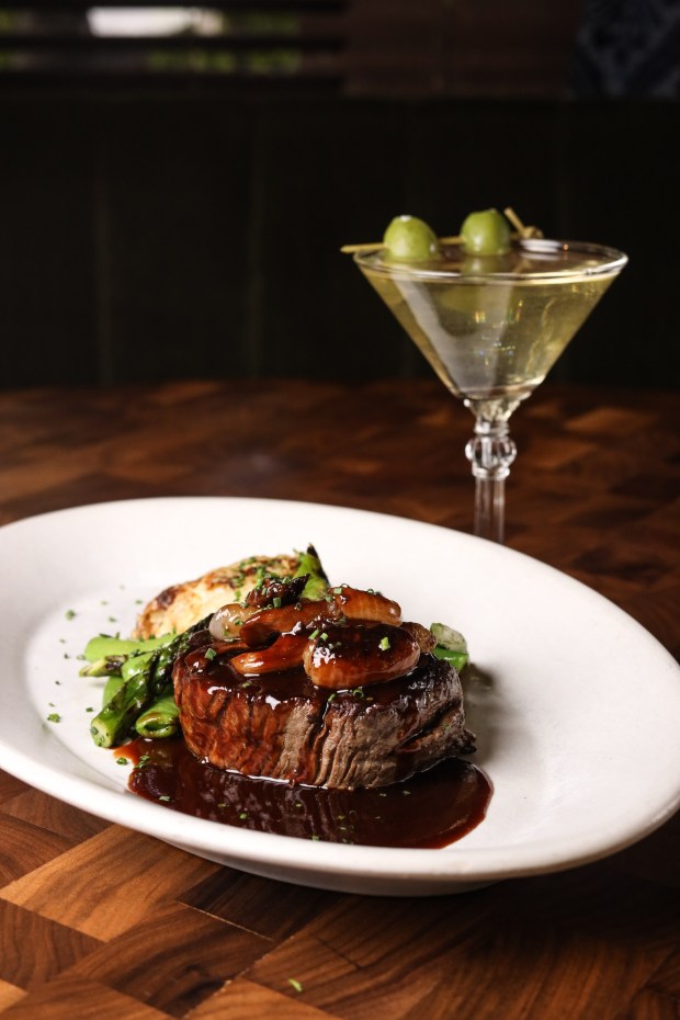 A steak dish and cocktail at The Henry, which opened its second location Wednesday in Carlsbad. (The Henry)