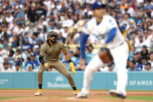 The Padres' Fernando Tatis Jr. leads off first base while the Dodgers' Shohei Ohtani pitches during the first inning Monday night at Dodger Stadium. (Photo by Harry How/Getty Images)